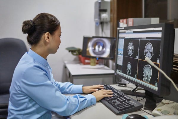 Radiologist analyzing X-ray image on computer. radiology information system workflow