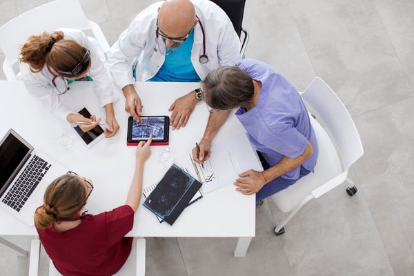 top radiology information systems doctors talking at table